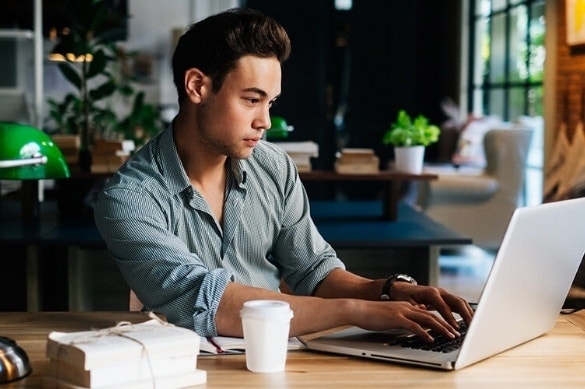 A lender working on a digital mortgage with Acrobat Sign on their laptop after hours