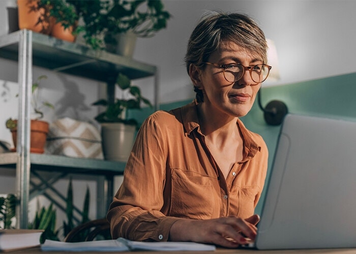 A small business owner looking over a digital contract on their laptop before signing it