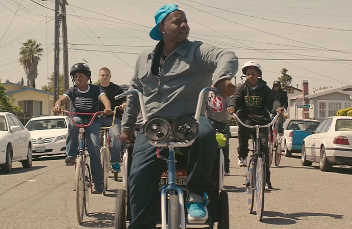 A person leading a group of people on bikes through a neighborhood