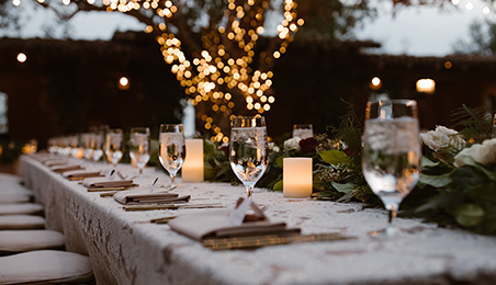 Bokeh wedding picture of a candle-lit table for the bride and groom.