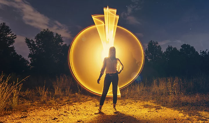 Person standing in front of a light painting