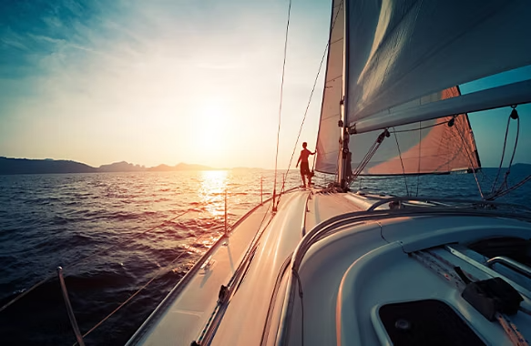 Cinematic back shot camera angle of a man sailing a boat.