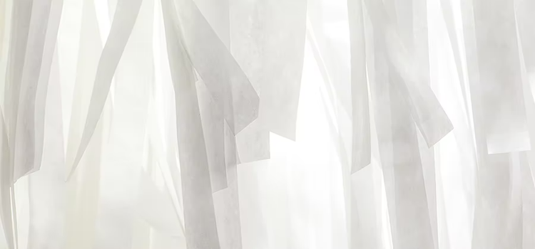 Strips of white cloth sheets being used to showcase the importance of white balance