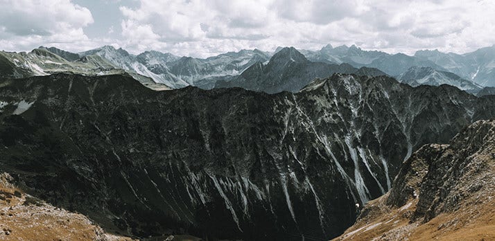 Dark, shadowed landscape shot of a distant mountain range