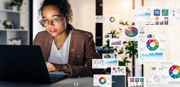 A woman works on a laptop surrounded by digital images of graphs, tables, and data, symbolising the merging of datasets into files.