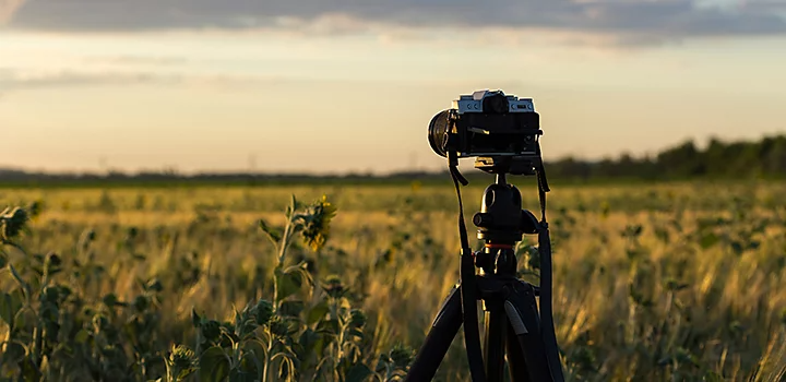 Photo of a camera on a tripod in a field