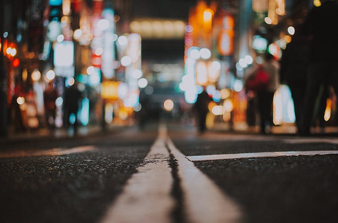 Close up photograph of a crack in the street taken at night