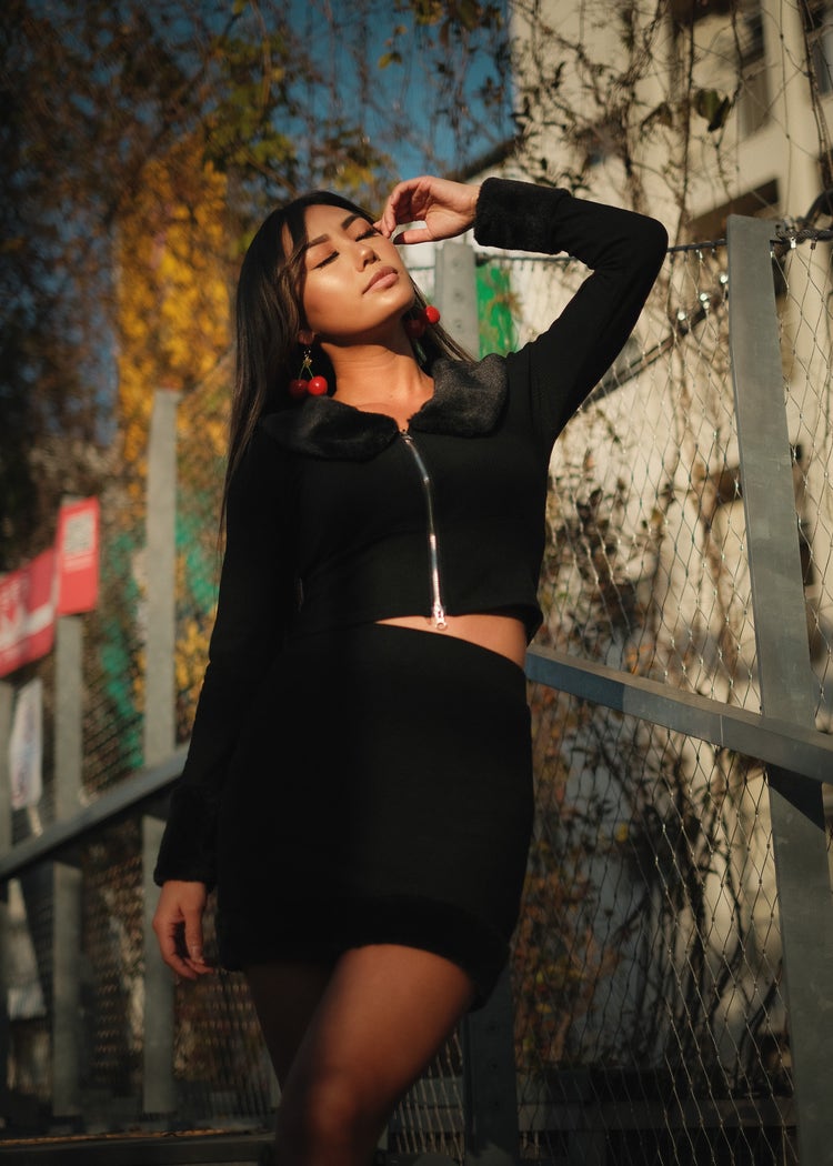 Outdoor portrait of model posing with sun shining from behind the photographer