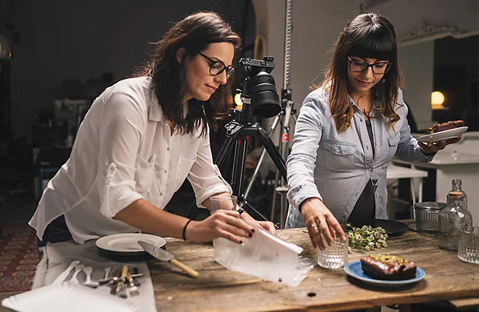 A photographer and production assistant setting up a commercial photo set