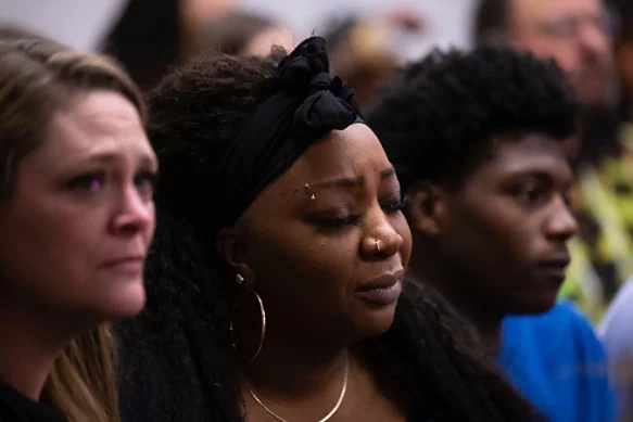 A photo of people mourning.