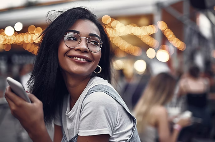 Una ragazza sorridente all'aperto con luci effetto bokeh