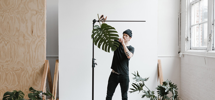 A photographer setting up props for a photoshoot