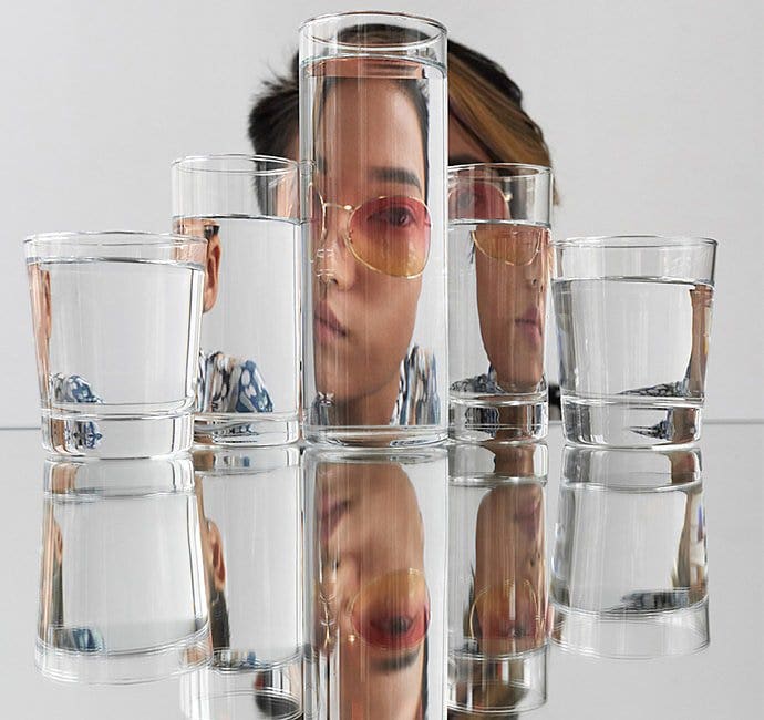 Self-portrait of someone through glasses of water