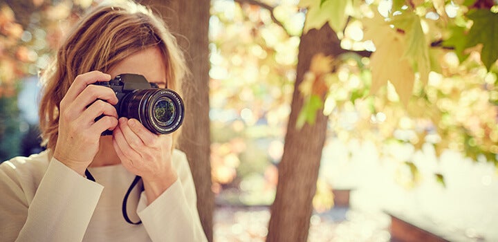 Woman taking a picture with a digital camera