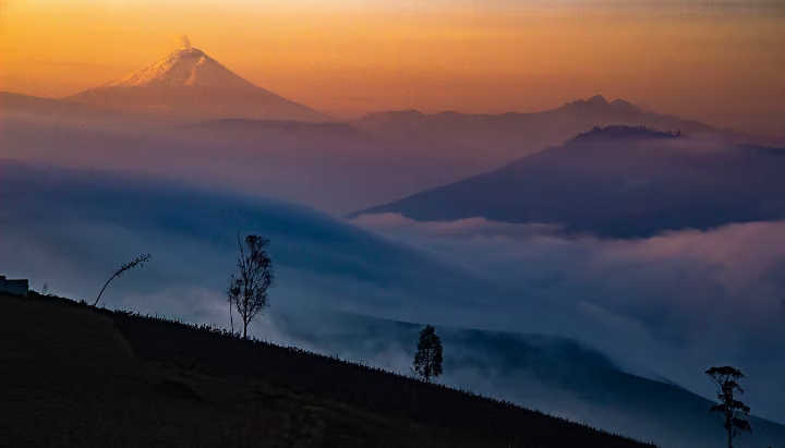 Snowcapped mountain in the distance and fog covering the horizon.