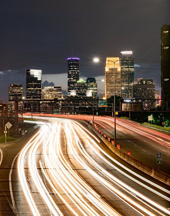 A blur of car lights captured from a highway running through a city