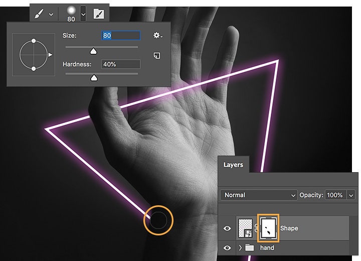Usa il pennello nero per creare una maschera di Photoshop che nasconda alcune parti della forma davanti al polso e al pollice