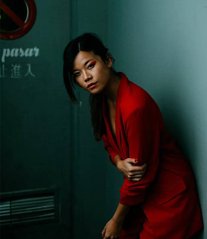 Model wearing a red outfit posing for a glamour photo