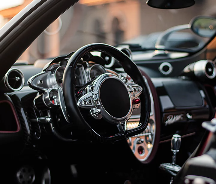 A customized steering wheel and dashboard of a sports car