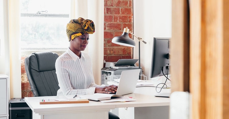 A business person works on their sales workflow at their desk