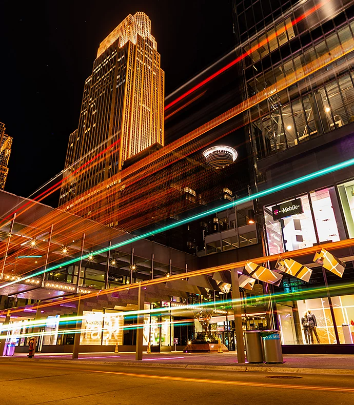 Motion blur of lights across a photo of buildings at night