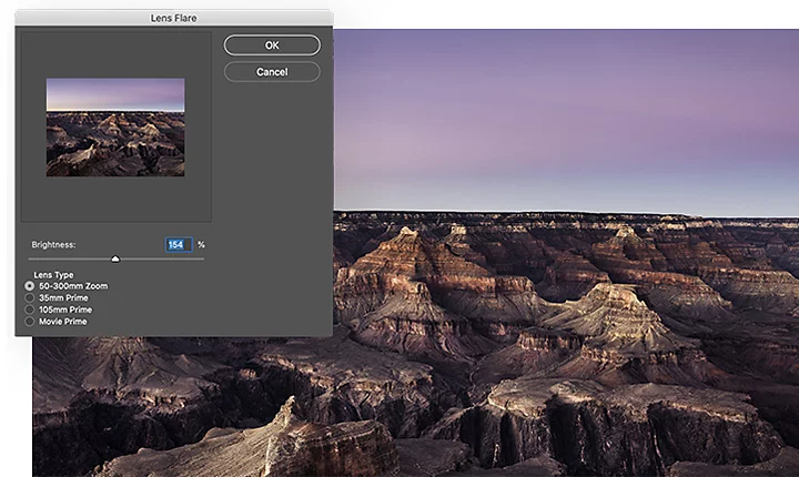 The Adobe Photoshop lens flare settings pane superimposed over an aerial shot of a rocky canyon