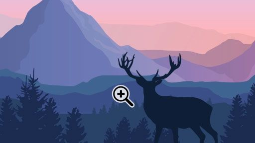 The silhouette of a deer with impressive antlers in front of distant mountains