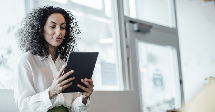 A person reviewing sales data on their tablet