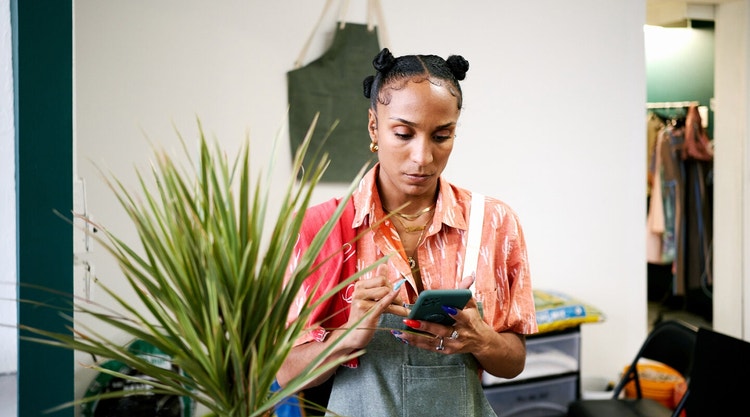 A small business owner reviewing data on their smartphone