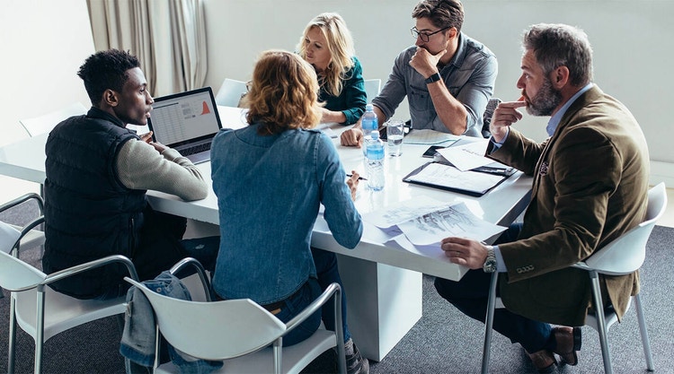 A sales team reviewing data in a meeting