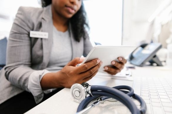 A doctor looking over a notice of privacy practices on a tablet using Adobe Acrobat Sign