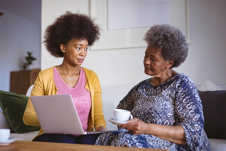 Two people sitting on a couch reviewing an affidavit together