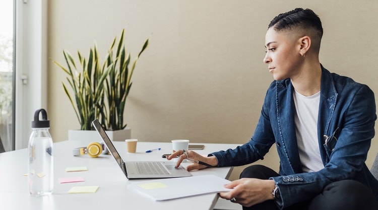 A person reviewing business loan documentation at a desk