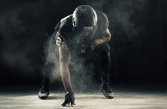 A dramatic studio photo of a football player.