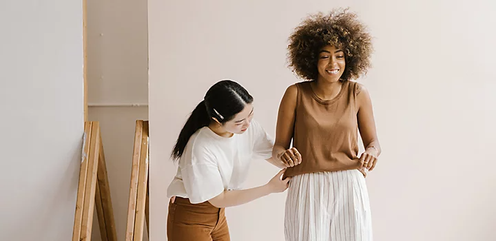 A stylist prepping a model for a fashion shoot