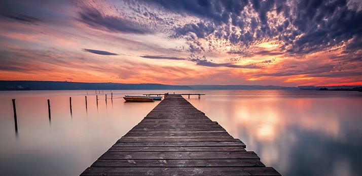 Beautiful landscape photo of a pier reaching out to the horizon