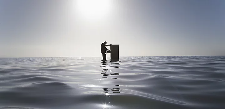 Someone opening a filing cabinet as they float above a body of water