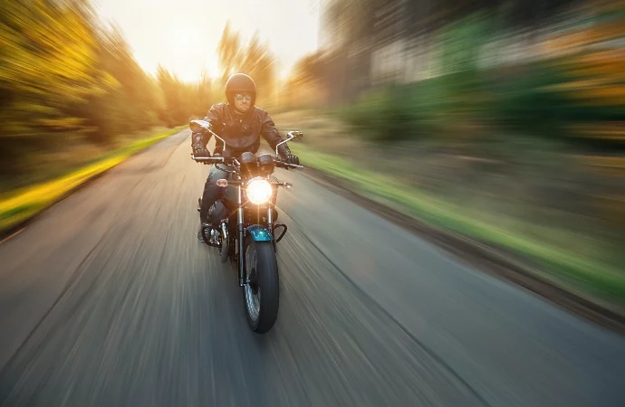 Motorcyclist riding on road with Gaussian blur