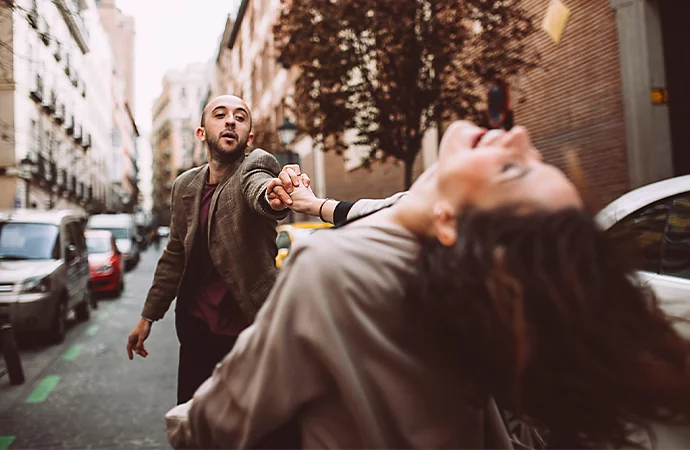 Two people dancing in the street as an example of lifestyle photography