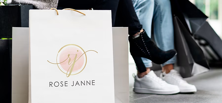 A watercolor logo design on a paper bag