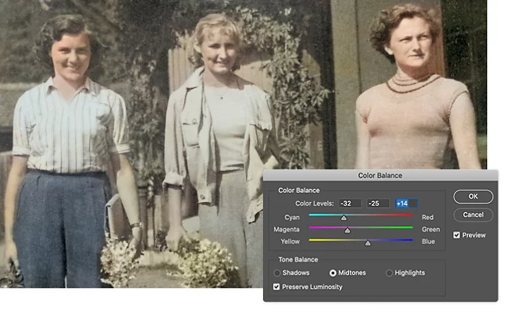 Color Balance tool superimposed on an old faded photo of three people standing in a garden. The photo's tones have been adjusted.