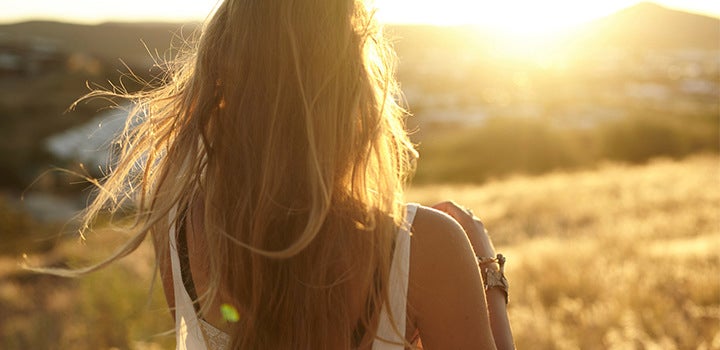 Natural light portrait photo of girl with her back turned.