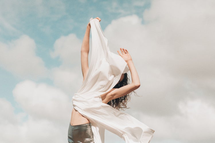 Editorial fashion photo of model posing with fabric