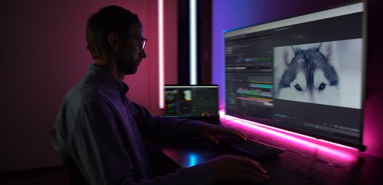 man editing video footage on a computer