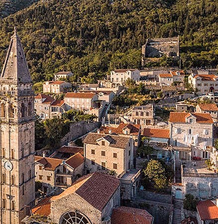 Aerial shot of a beautiful old town nestled at the foot of a hill