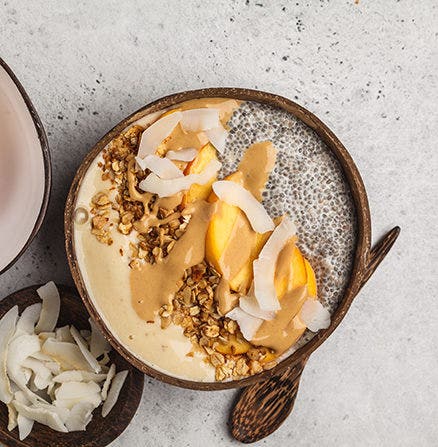 Breakfast food photo of peanut butter and coconut flake topped granola