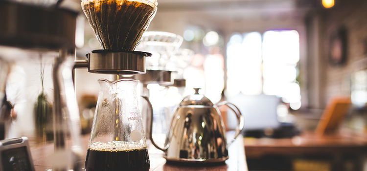 Shallow depth of field picture of coffee brewing in a coffee shop