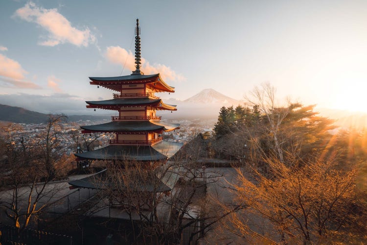 Natural light shining on temple and Mount Fuji