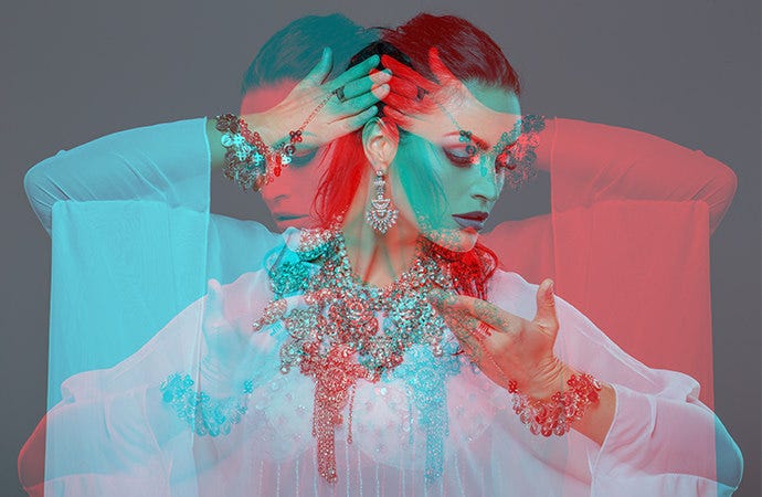 Double exposed image of woman in two poses with a blue and red overlay.