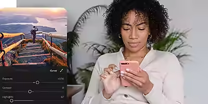A person sitting and editing a photo on their phone with Adobe Photoshop Lightroom